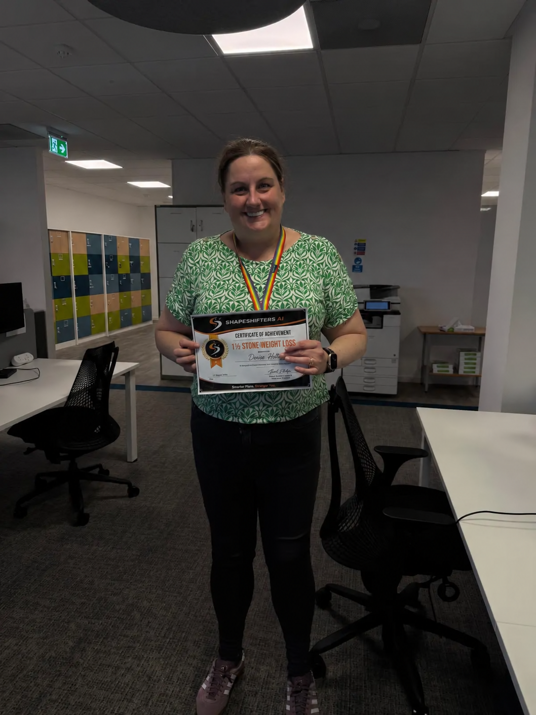 Denise Holte holding her ShapeShifters one-and-a-half-stone weight-loss achievement certificate